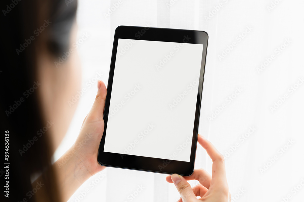 Woman hand using digital tablet and the screen is blank.