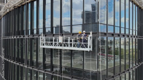 Office window installation worker in the construction site. House development. Business econpmy travel or industrial concept b-roll footage, drone aerial view in Shanghai China cityscape in background