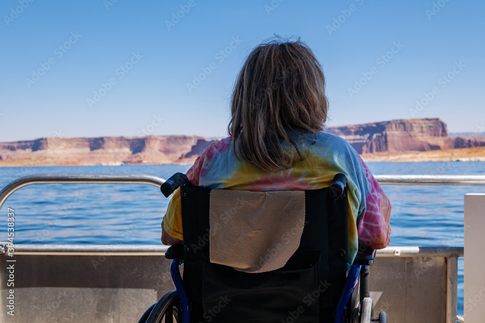 Fototapeta premium Woman in wheelchair on boat at Lake Powell enjoys the vista