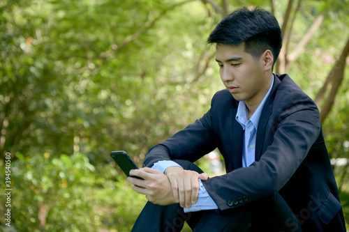 asian businessman working in park