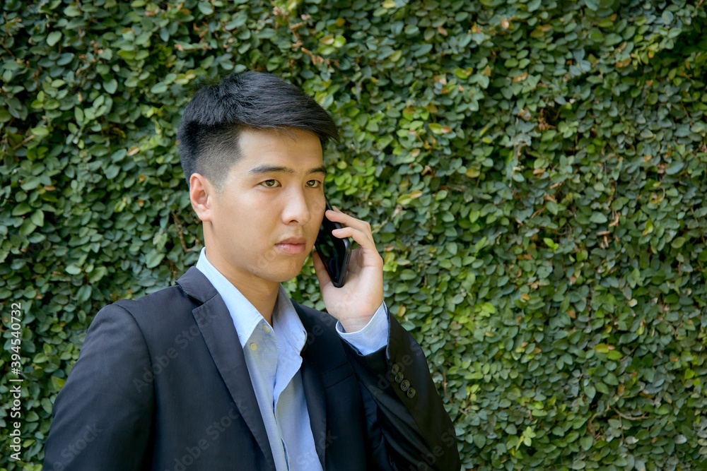 asian businessman working in park