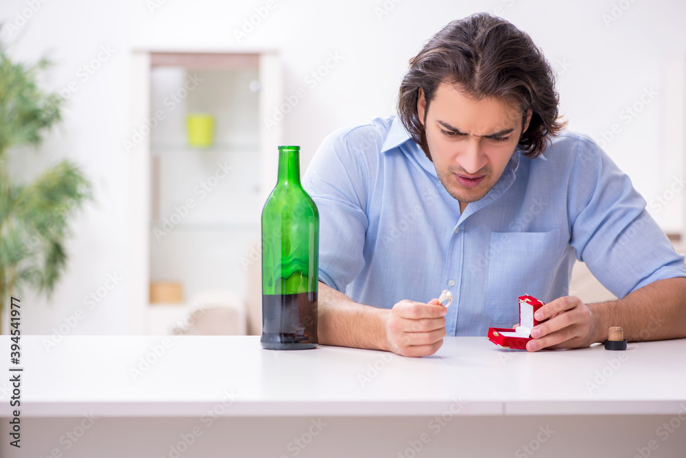 Young male alcoholic in unrequited love concept Young male alcoholic in unrequited love concept