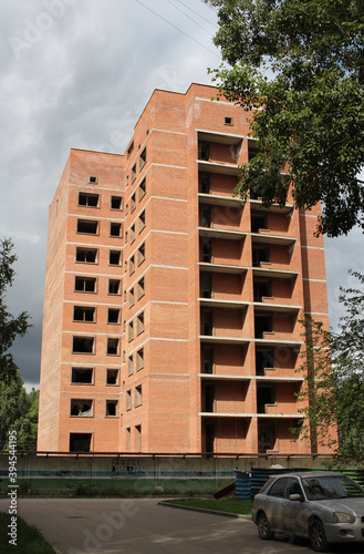multi-storey building under construction with Windows against the sky with clouds