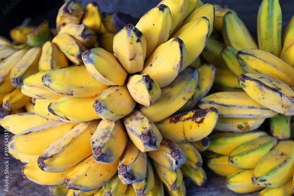 Fresh bananas for sale at a market stall.