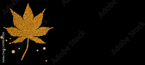 Gold maple leaf on on black background. merry christmas and happy new year.