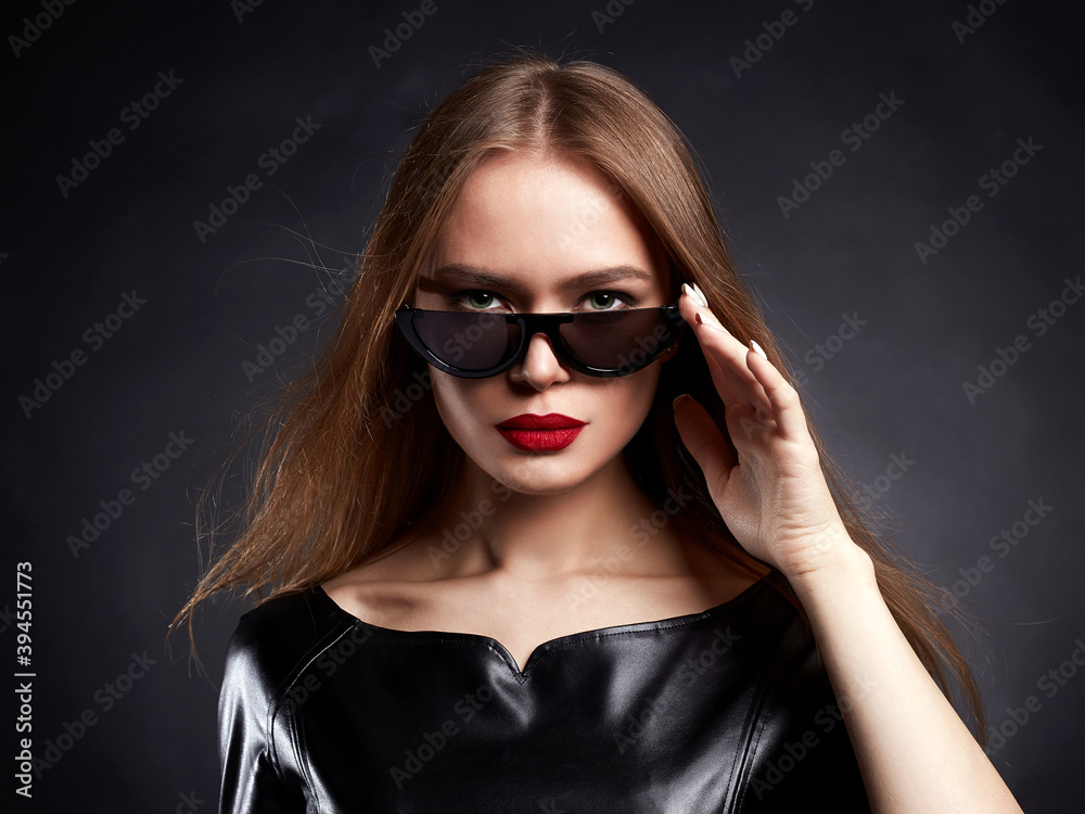 Beautiful young Woman with healthy Hair in Sunglasses Beautiful young Woman with healthy Hair in Sunglasses