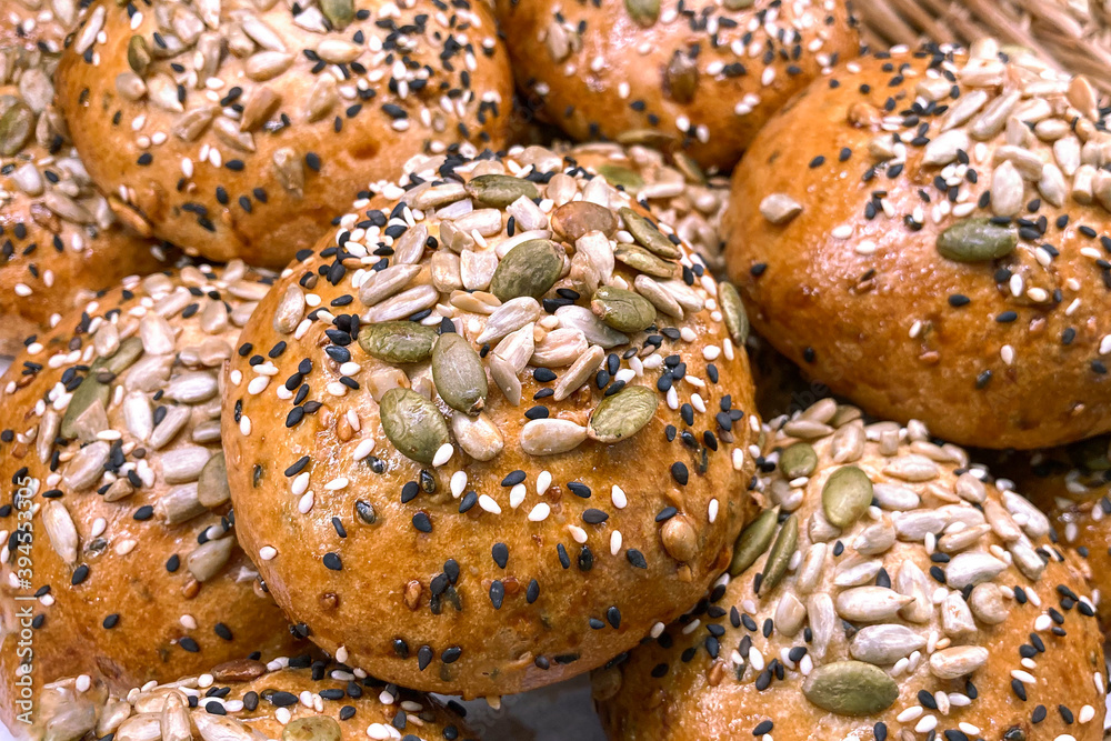 Whole grain bread bun containing sesame, pumpkin seeds, sunflower seeds topping Whole grain bread bun containing sesame, pumpkin seeds, sunflower seeds topping