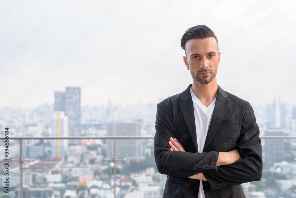 Portrait of businessman standing on the rooftop of a skyscraper Portrait of businessman standing on the rooftop of a skyscraper