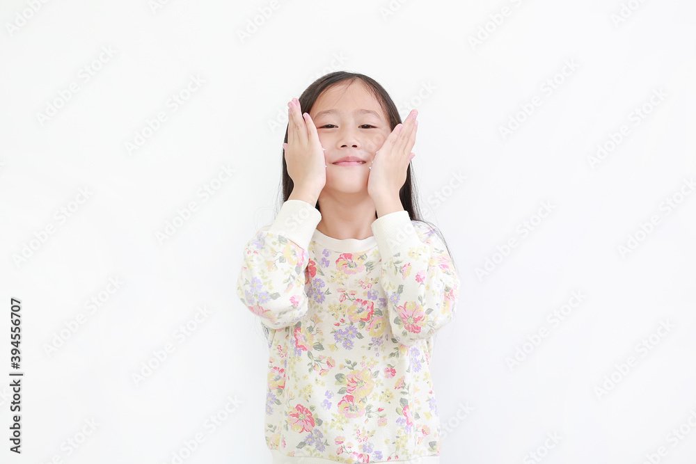 Little asian kid girl apply baby lotion on her face isolated on white background Little asian kid girl apply baby lotion on her face isolated on white background