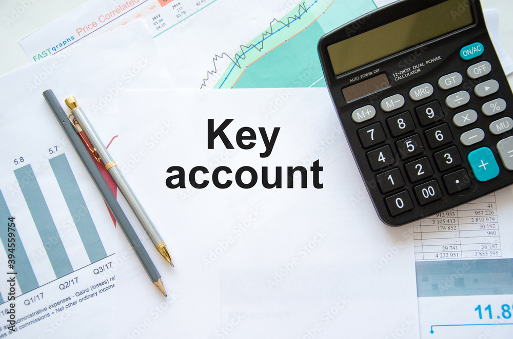 the word key account is written on a white sheet of paper which is a financial statement with a calculator and a pen the word key account is written on a white sheet of paper which is a financial statement with a calculator and a pen