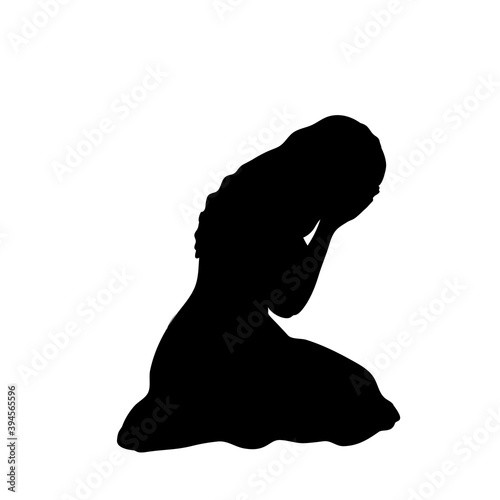 Silhouette of girl sitting on her knees crying