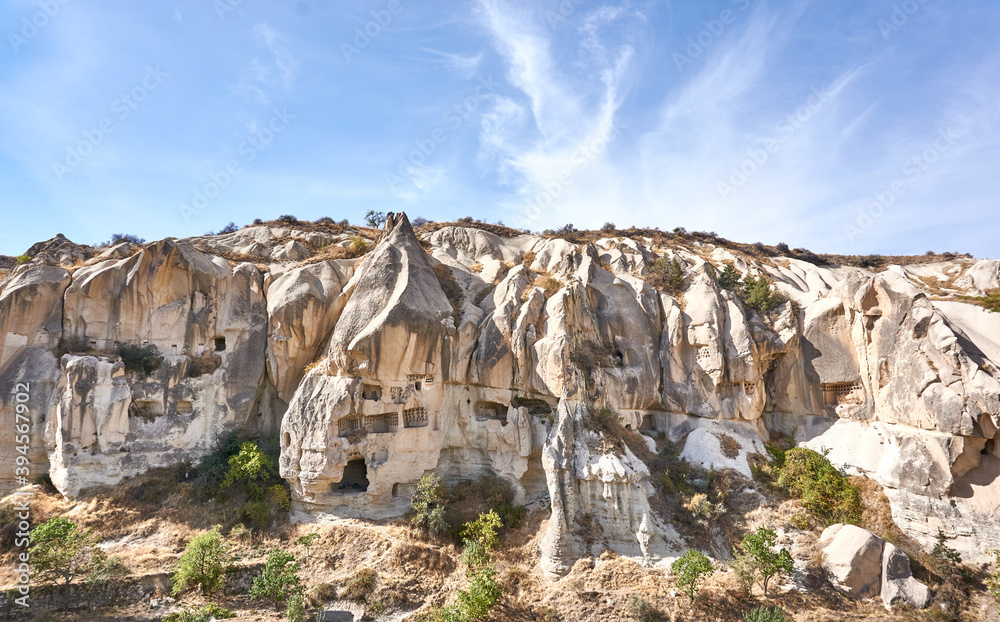 Fototapeta premium Ancient cave houses and rock formations near Goreme, Cappadocia, Turkey