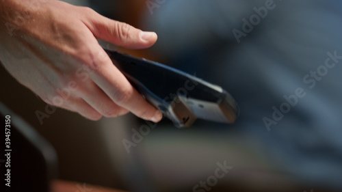 Businesswoman hand making payment with credit card through pos terminal