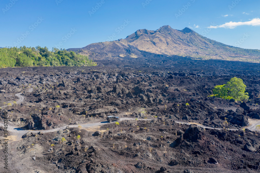 Off road vehicle move on slopes of Batur volcano