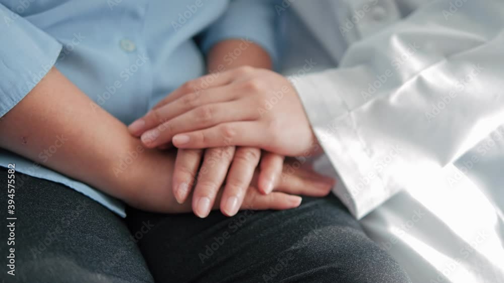 Doctor supporting senior patient after reading bad analysis results at clinic, Close up of Female nurse doctor wear white uniform hold hand of senior grandmother patient. Doctor supporting senior patient after reading bad analysis results at clinic, Close up of Female nurse doctor wear white uniform hold hand of senior grandmother patient.