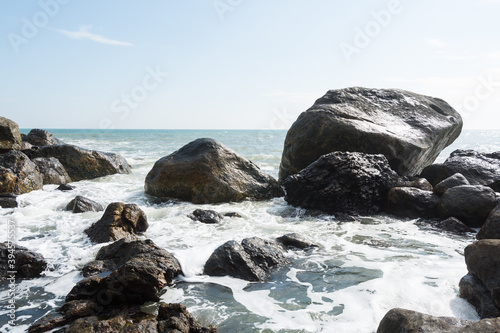Seascape of waves splashing the stones in the rocky coastline of Yangxi, Yangjiang of China photo