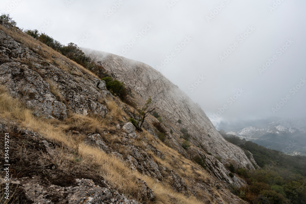 Mount Ilyas Kaya in the clouds, near the village of Laspi, Republic of Crimea, Russia. Cloudy day September 25, 2020
