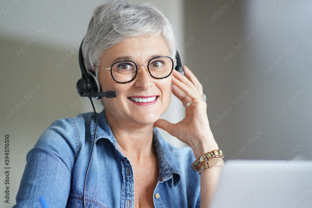 Mature woman with grey short hair working from home during pandemia Mature woman with grey short hair working from home during pandemia