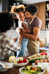 Happy family preparing healthy food in kitchen together