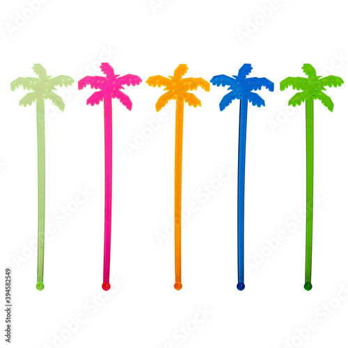 Decoration of colored transparent cocktail sticks in the shape of a palm tree. Isolated on white