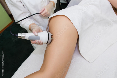 Anti-cellulite massage RF-lifting of thighs.