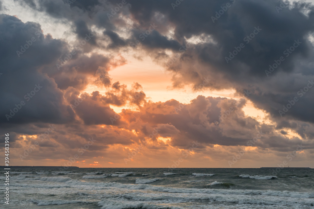 Golden sunset with dramatic cloudscape over the sea.