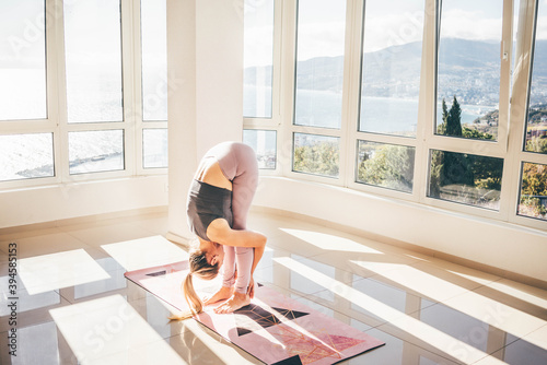 Top view. Beautiful young woman in sportswear doing yoga on mat. photo