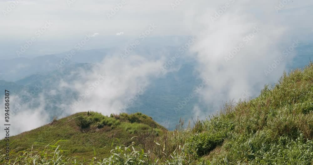 Green mountain view of moving white clouds and fog blowing in the wind. foggy mountains Green mountain view of moving white clouds and fog blowing in the wind. foggy mountains