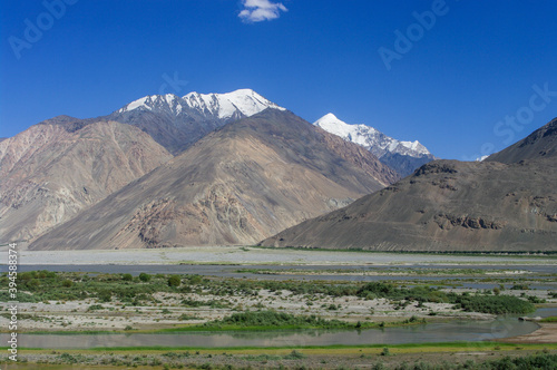 Landscape view of Hindu Kush snow-capped mountains on Afghan side of Panj river valley in Wakhan Corridor  Gorno-Badakshan  Tajikistan Pamir