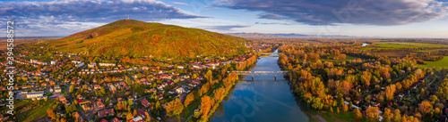 Fotografía Tokaj, Hungary - Ultra wide aerial panoramic view of the small town of Tokaj with golden vineyards on the hills of wine region on a warm sunny autumn morning