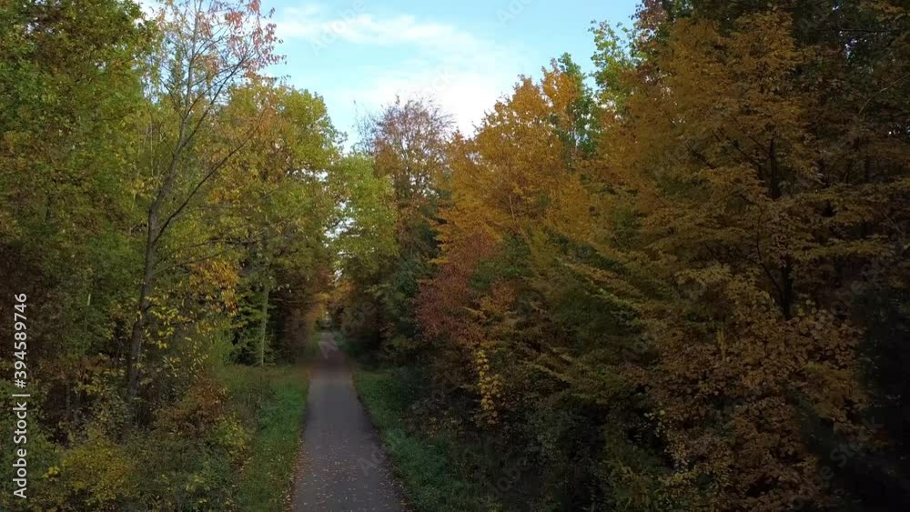 Aerial view of a drone ascending in an autumn forest. Fall landscape with red, yellow and green foliage on a sunny October day near Stuttgart in southern Germany. Aerial view of a drone ascending in an autumn forest. Fall landscape with red, yellow and green foliage on a sunny October day near Stuttgart in southern Germany.