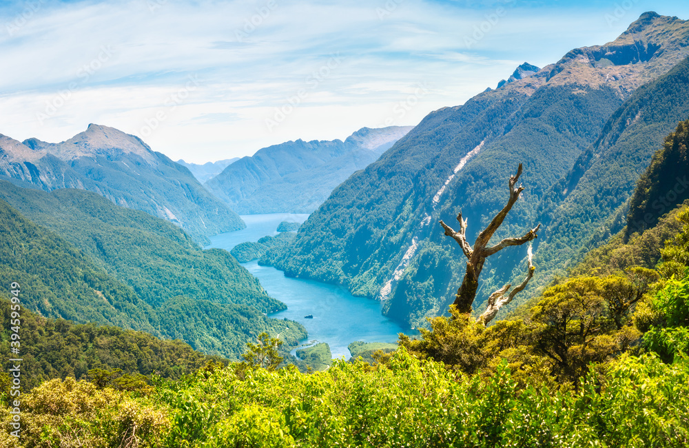 Doubtful Sound View Point looking down to the spectacular fjord from the top of the mountain on a beautiful day in summer, in a very remote location in New Zealand, South Island.