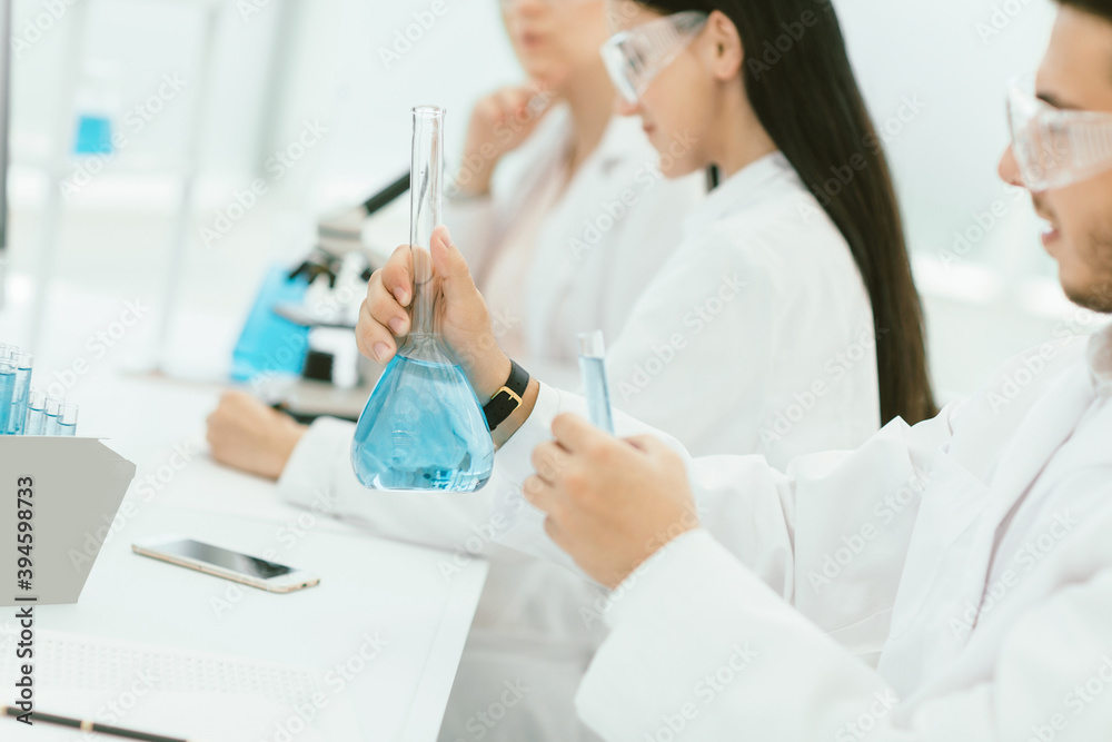 group of scientists conduct research liquid in a test tube group of scientists conduct research liquid in a test tube