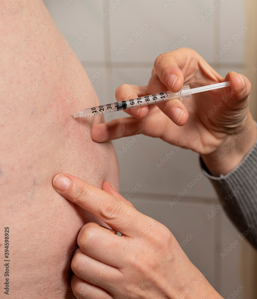 Close Up photo of woman making injection in bottom Close Up photo of woman making injection in bottom