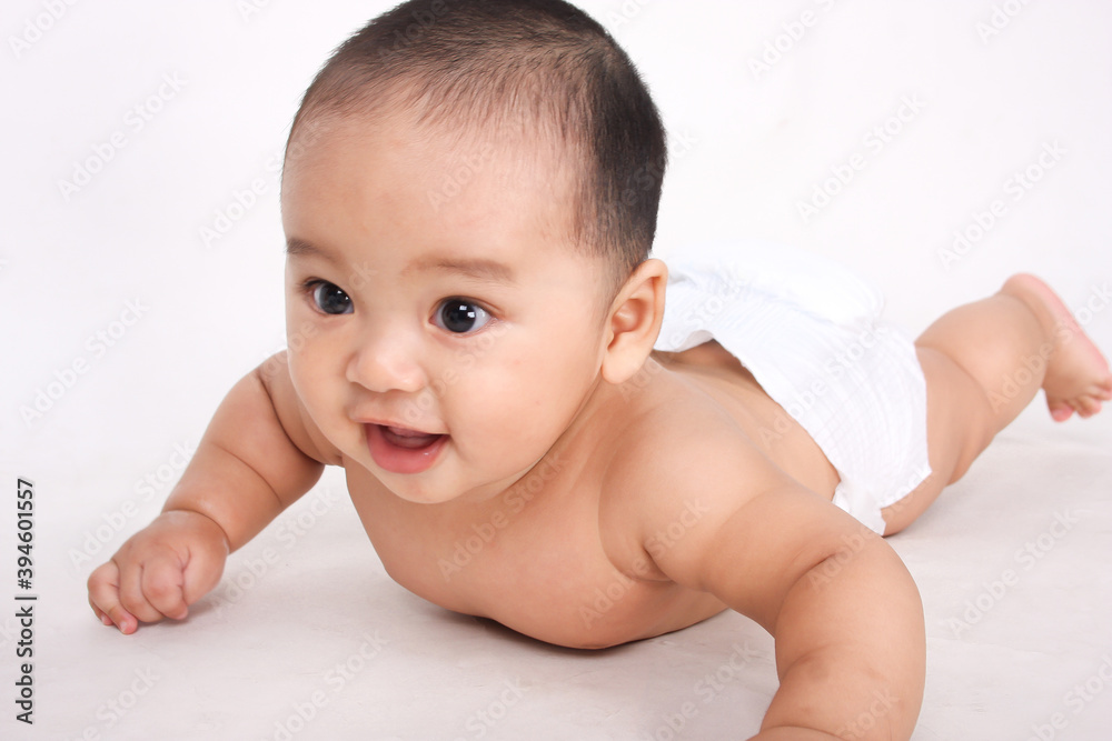 Cute Asian baby crawling and smiling on white background Cute Asian baby crawling and smiling on white background