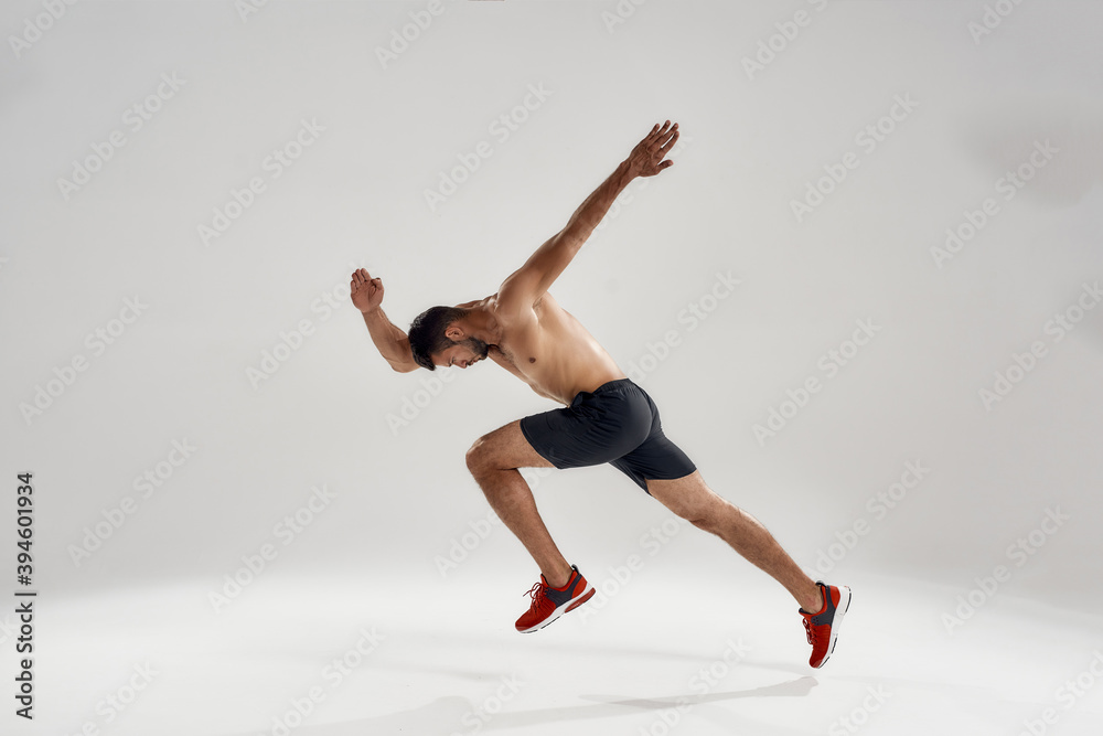 Young handsome caucasian male athlete running wide to side