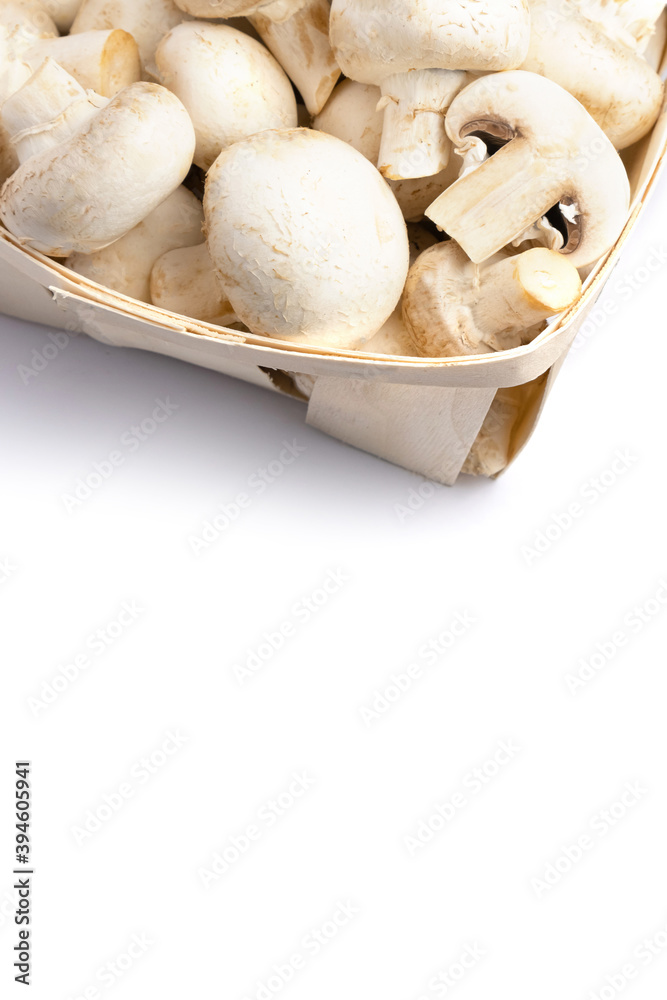 Fresh champignons in a basket isolated on white background. Fresh champignons in a basket isolated on white background.