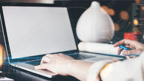 Woman with laptop distant working alone. Writing down with keyboard. Big blank screen. Remote studiyng at home. Hands close-up wide screen photo