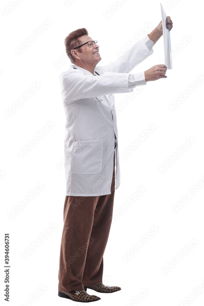male doctor looking at an x- ray of a patient. isolated on a white male doctor looking at an x- ray of a patient. isolated on a white
