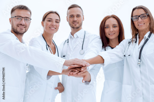 group of young doctors putting their palms together.