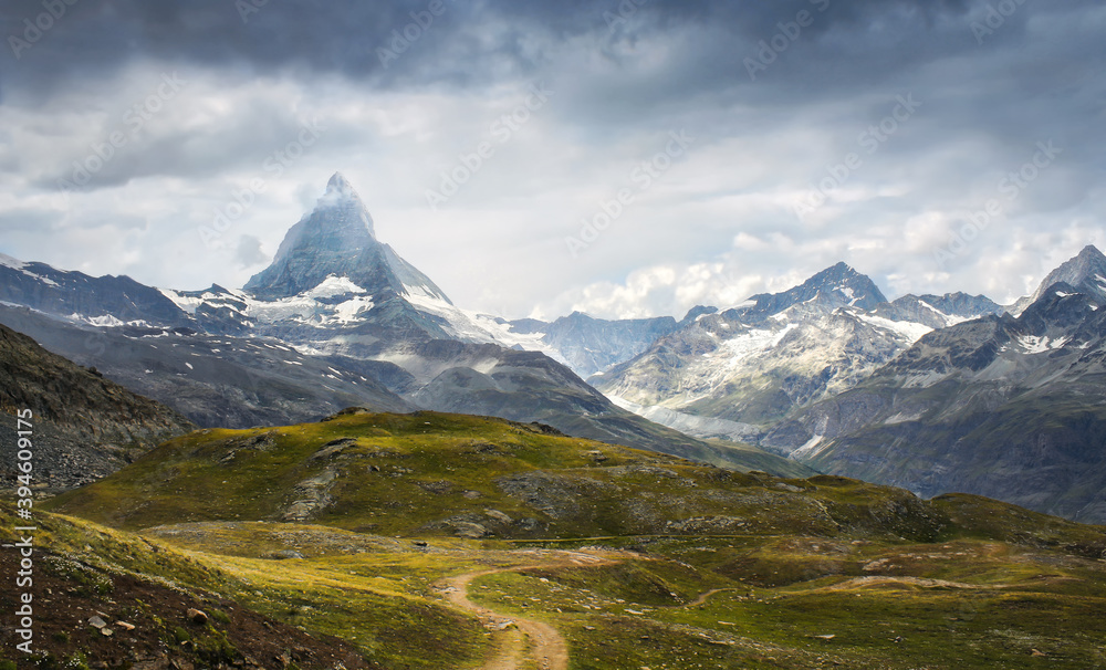 Fototapeta premium Matterhorn and its green surroundings with a spectacular sky