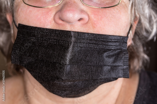 Fényképezés Black protective mask wearing incorrectly with an open nose