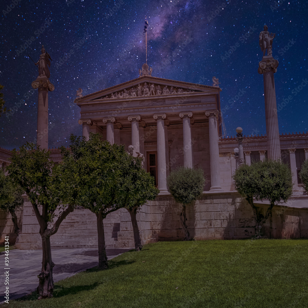 The National academy of Athens classic building with Athena and Apollo statues under starry sky, Athens Greece