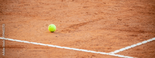 Tennis ball on red clay courts near defocused lines, competitive sport concept, no people © fabioderby