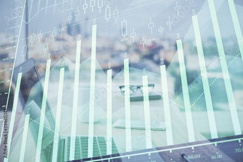 Forex graph hologram on table with computer background. Multi exposure. Concept of financial markets.