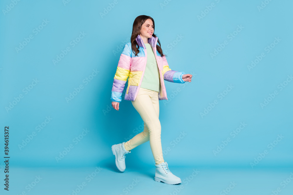 Photo portrait full body view of walking woman isolated on pastel blue colored background Photo portrait full body view of walking woman isolated on pastel blue colored background