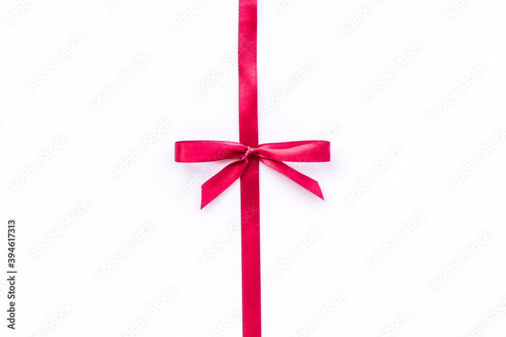 Red ribbon bow on white background, top view, copy space Red ribbon bow on white background, top view, copy space