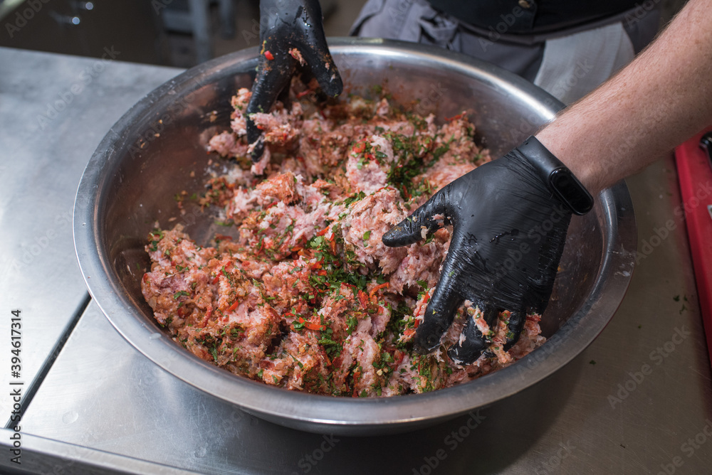 Fototapeta premium The chef mixes minced pork with different ingredients