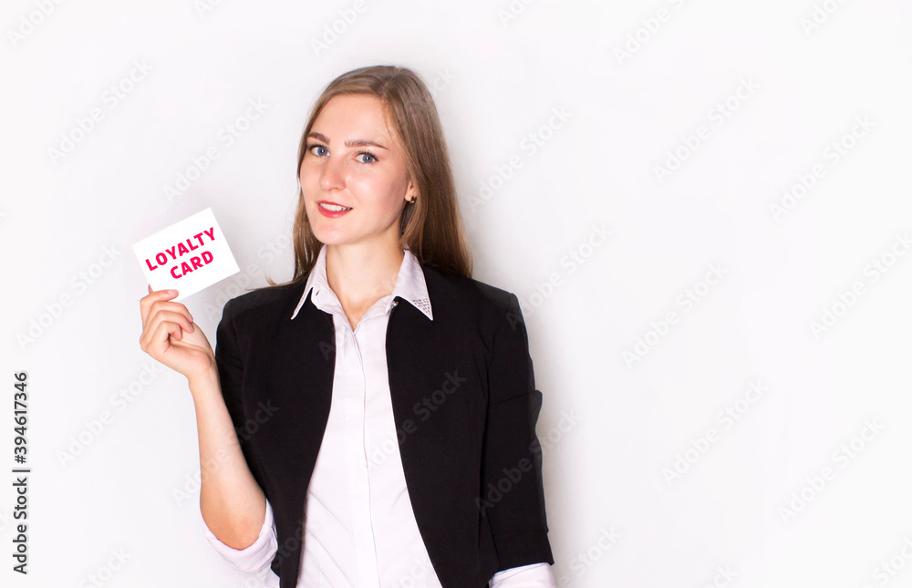 Businesswoman in a business suit show loyalty card on a white background Businesswoman in a business suit show loyalty card on a white background
