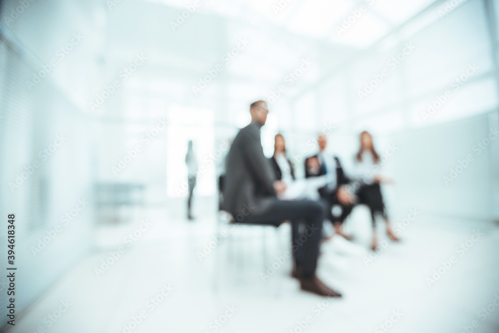 blurry image of a working group discussing business documents. blurry image of a working group discussing business documents.